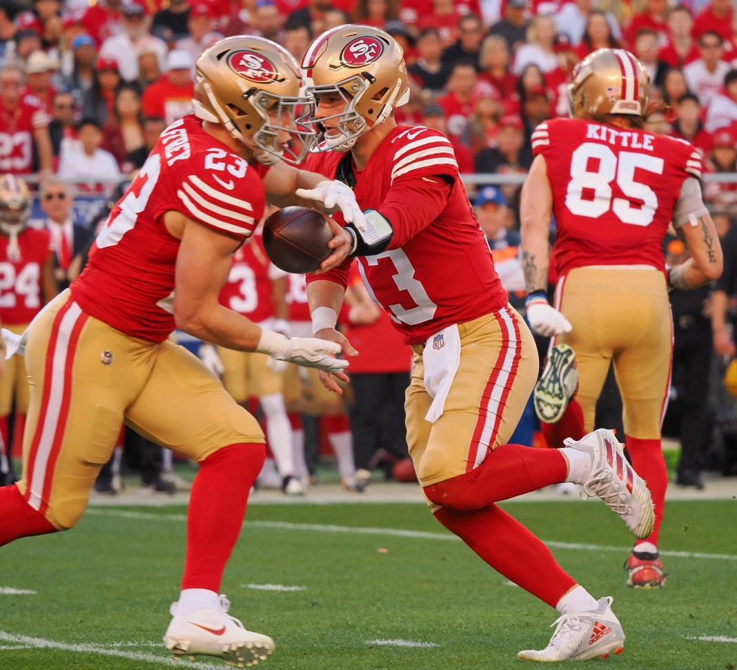 San Francisco 49ers quarterback Brock Purdy (13) hands the ball off to running back Christian McCaffrey (23)