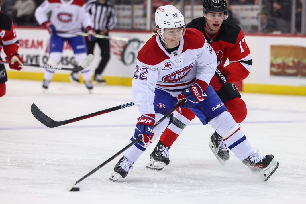 Montreal Canadiens right wing Cole Caufield (22) skates with the puck while being defended by New Jersey Devils defenseman Simon Nemec (17) during the first period at Prudential Center