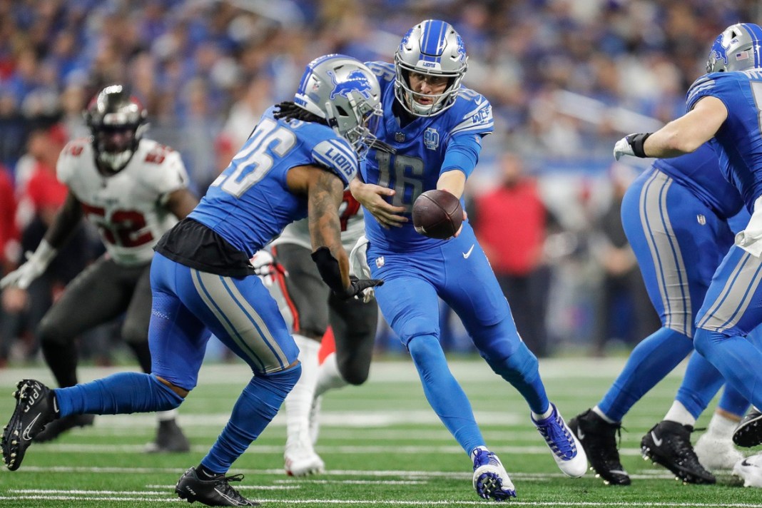 Detroit Lions quarterback Jared Goff hands the ball to running back Jahmyr Gibbs against Tampa Bay Buccaneers in the NFC divisional roun..