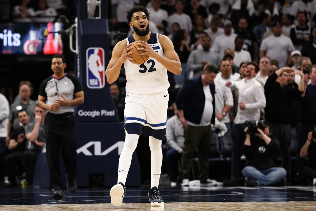 Minnesota Timberwolves center Karl-Anthony Towns (32) reacts after being charged with a foul against the Denver Nuggets