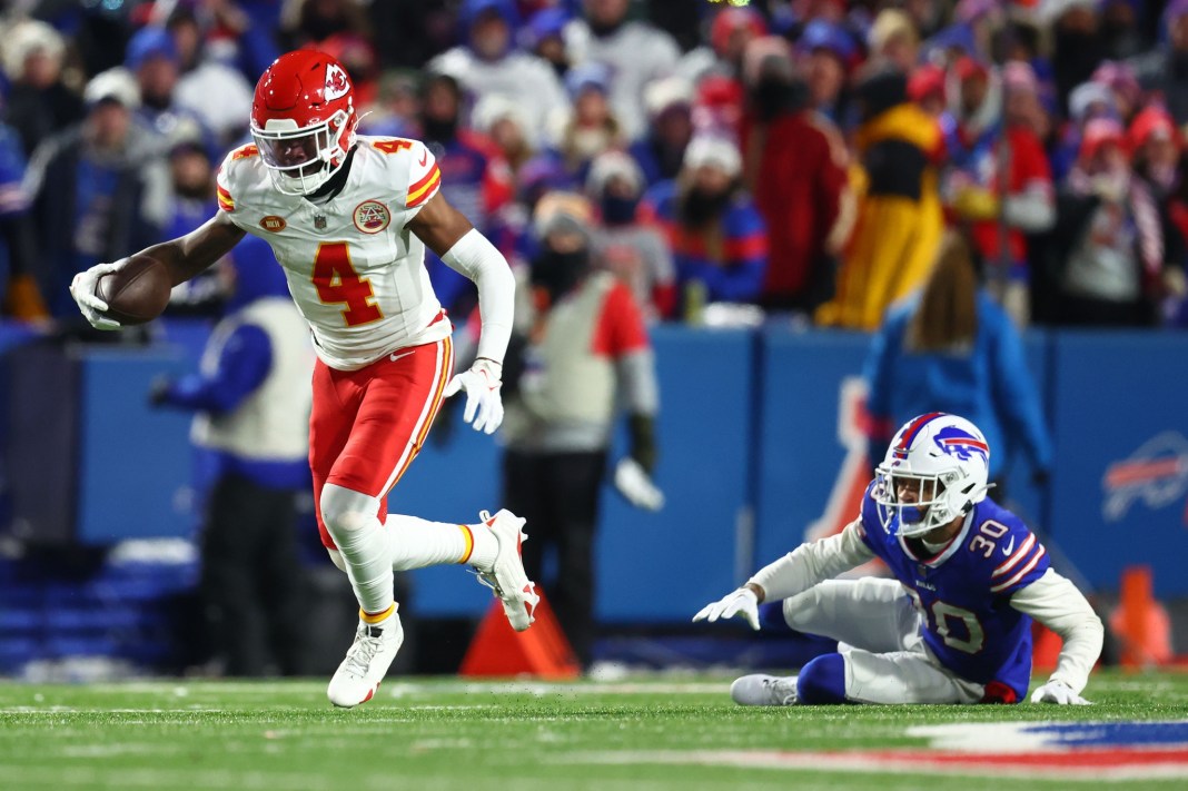 Kansas City Chiefs' Rashee Rice runs with the ball after a catch against Buffalo Bills' Dane Jackson in the 2024 AFC divisional round.