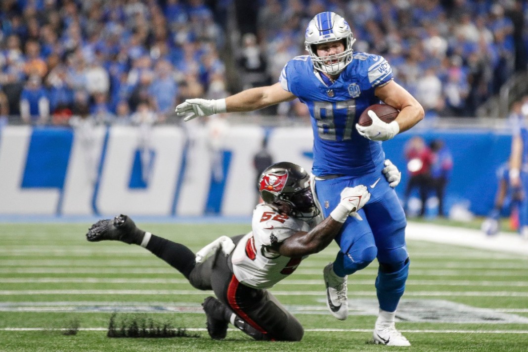 Detroit Lions' Sam LaPorta runs for a first down against Tampa Bay Buccaneers linebacker K.J. Britt during the 2024 NFC divisional round.