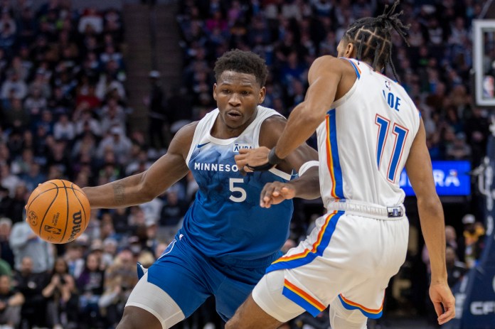 Timberwolves' Anthony Edwards dribbles as Thunder's Isaiah Joe defends.