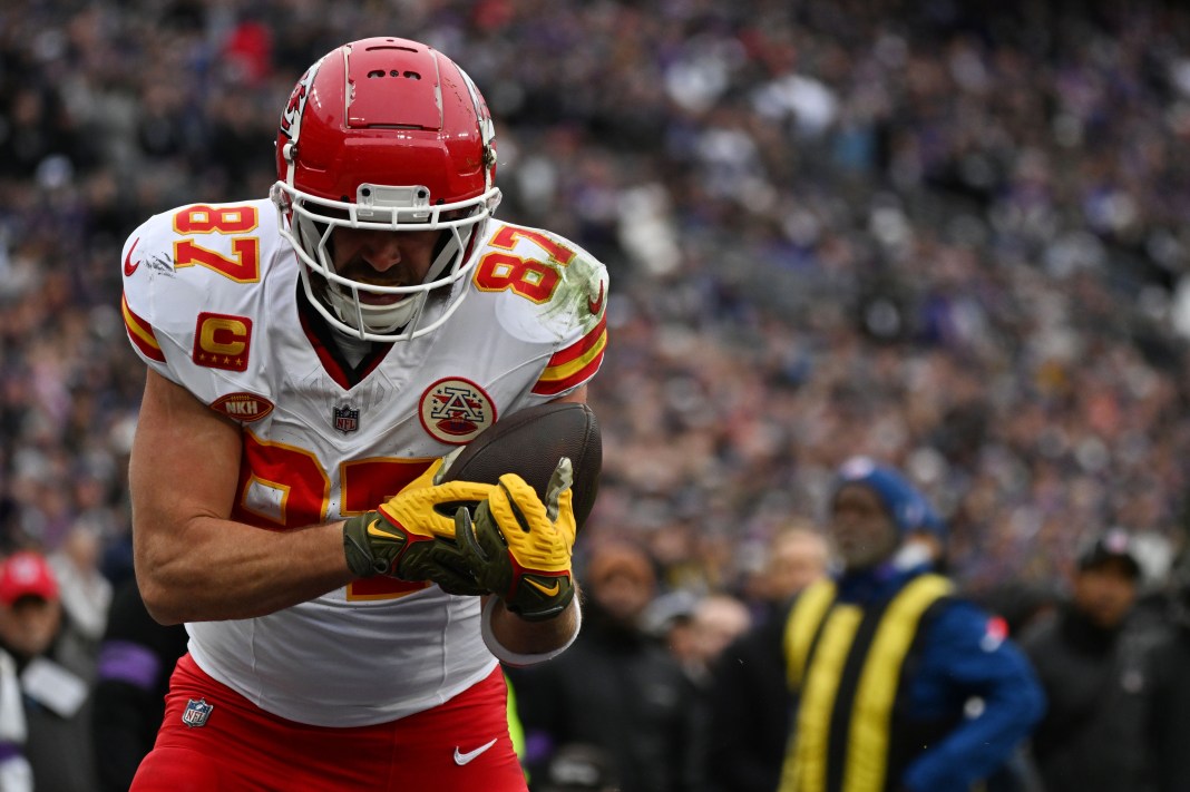 Kansas City Chiefs tight end Travis Kelce (87) catches a touchdown pass in front of Baltimore Ravens safety Kyle Hamilton (not pictured) defends in the AFC Championship football game