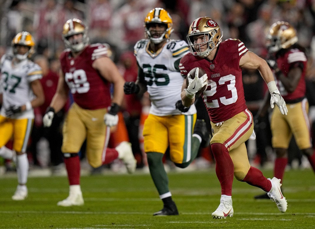 San Francisco 49ers running back Christian McCaffrey scores a touchdown on a 39-yard run during an NFC divisional playoff game.