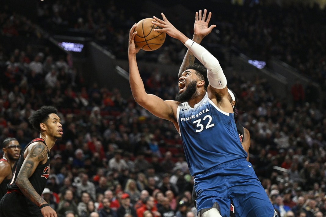 Minnesota Timberwolves center Karl-Anthony Towns (32) drives to the basket during the first half against Portland Trail Blazers forward Jerami Grant (9) at Moda Center