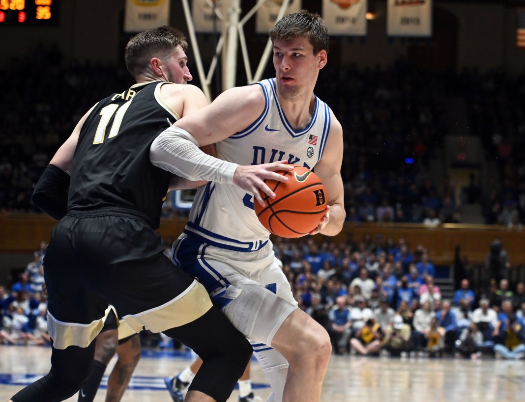 Duke Blue Devils center Kyle Filipowski (30) spins to the basket as Wake Forest Deamon Deacons forward Andrew Carr (11) defends during the second half at Cameron Indoor Stadium