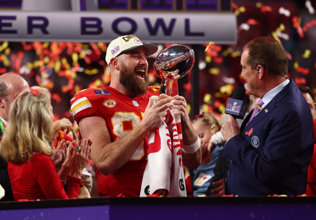 Kansas City Chiefs tight end Travis Kelce (87) celebrates with the Vince Lombardi Trophy after defeating the San Francisco 49ers in Super Bowl LVIII at Allegiant Stadium