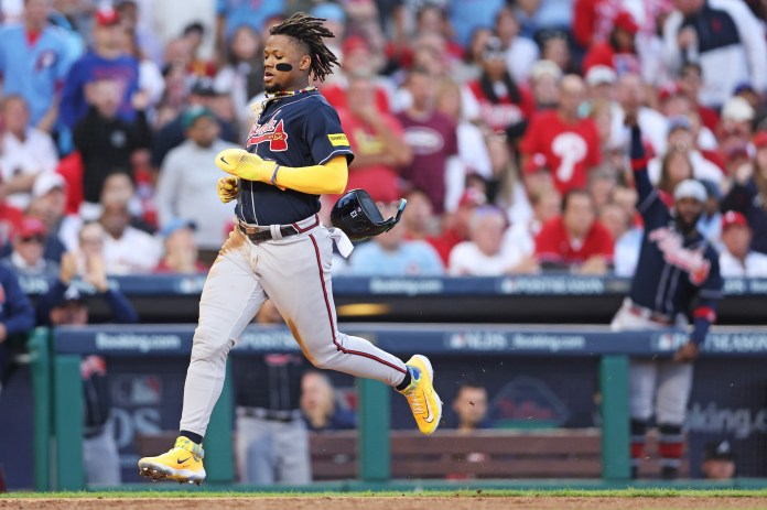 Atlanta Braves right fielder Ronald Acuna Jr. scores a run on a hit by second baseman Ozzie Albies.