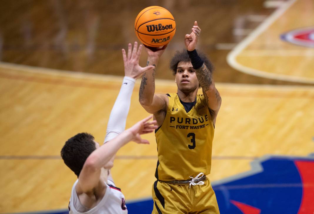 Purdue Fort Wayne’s Quinton Morton-Robertson takes a shot over Southern Indiana’s Jack Mielke.