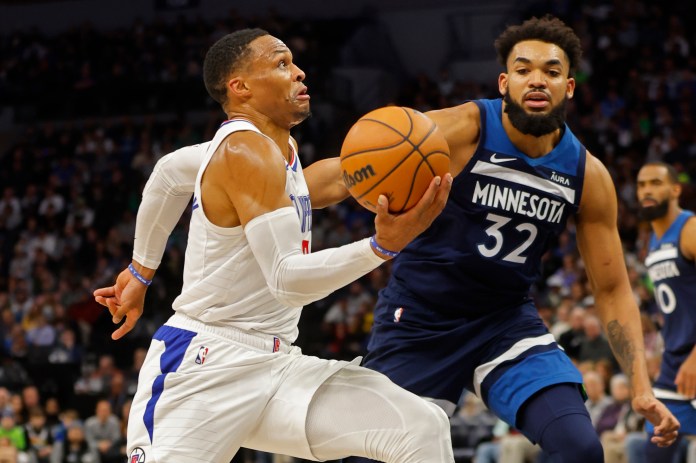 Los Angeles Clippers guard Russell Westbrook (0) drives to the basket past Minnesota Timberwolves forward Karl-Anthony Towns (32)