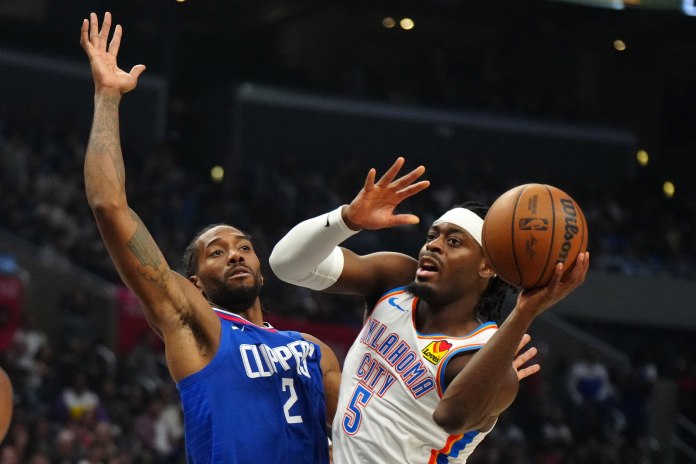 Oklahoma City Thunder guard Luguentz Dort passes the ball against LA Clippers forward Kawhi Leonard in the second half at Crypto.com Arena.