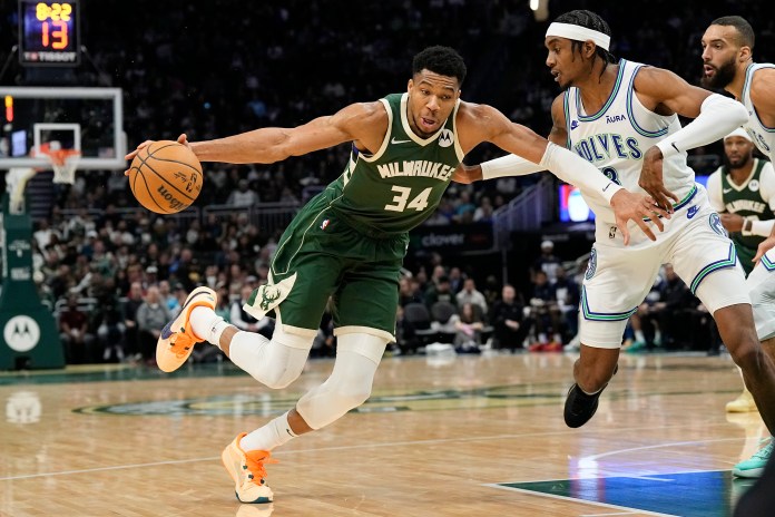 Milwaukee Bucks forward Giannis Antetokounmpo (34) drives for the basket against Minnesota Timberwolves forward Jaden McDaniels (3)