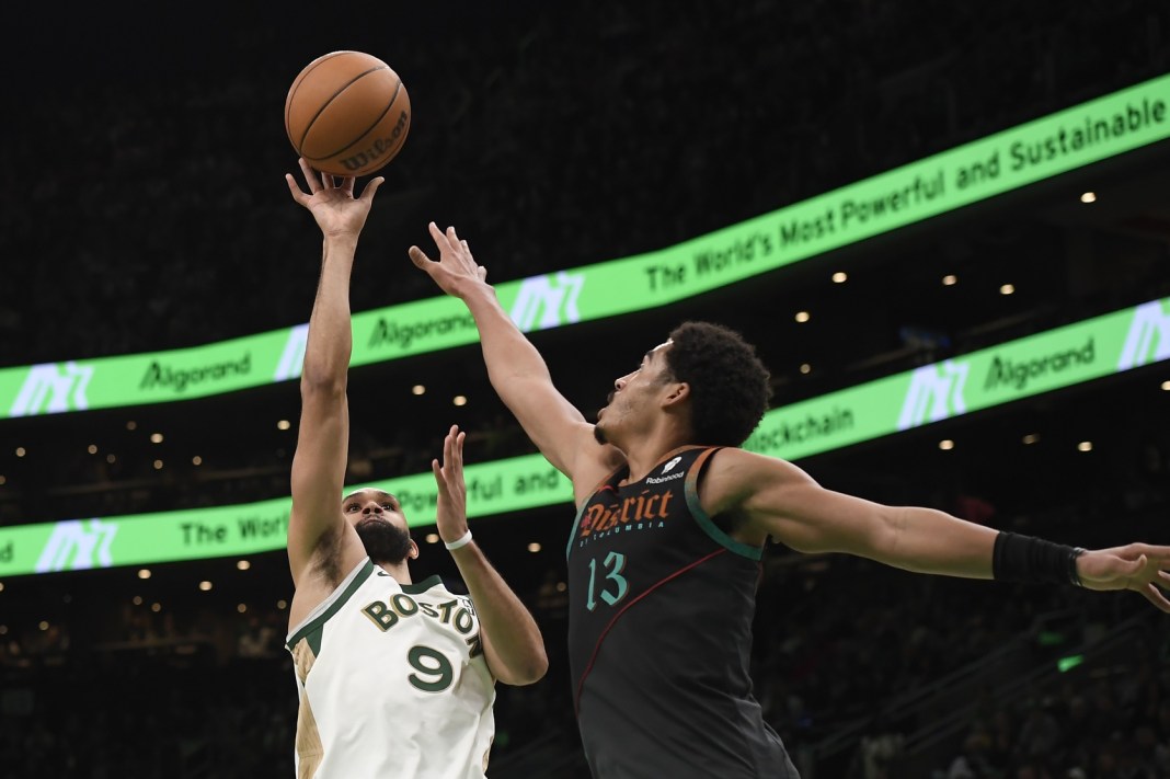 Boston Celtics guard Derrick White shoots the ball over Washington Wizards guard Jordan Poole during the second half at TD Garden.