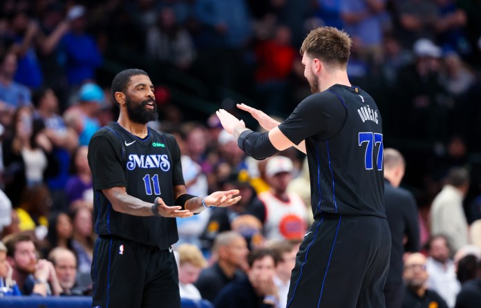 Dallas Mavericks stars Luka Doncic and Kyrie Irving celebrate with one another in a meeting with the Phoenix Suns.