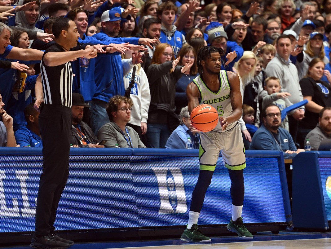 Queens Royals guard AJ McKee is harassed by Duke Blue Devils fans as he attempts to inbound the ball.