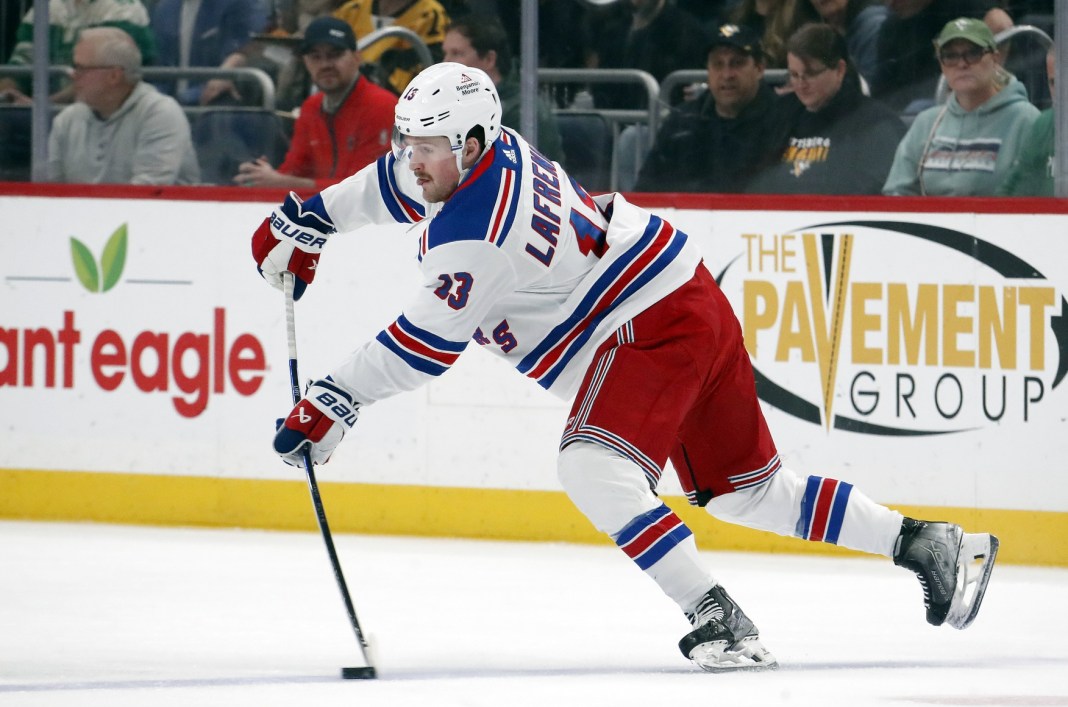 New York Rangers left wing Alexis Lafreniere passes the puck against the Pittsburgh Penguins during the first period at PPG Paints Arena.