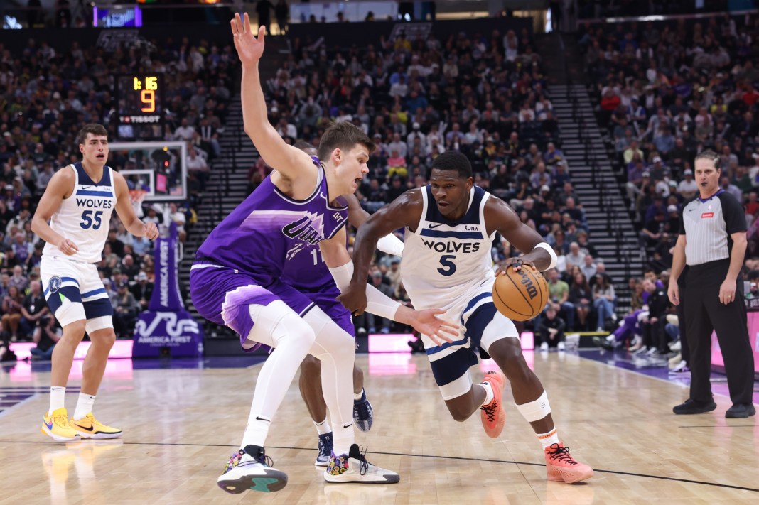 Minnesota Timberwolves guard Anthony Edwards (5) drives against Utah Jazz center Walker Kessler (24)