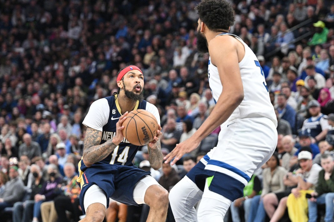 New Orleans Pelicans forward Brandon Ingram (14) looks to shoot as Minnesota Timberwolves center Karl-Anthony Towns (32)