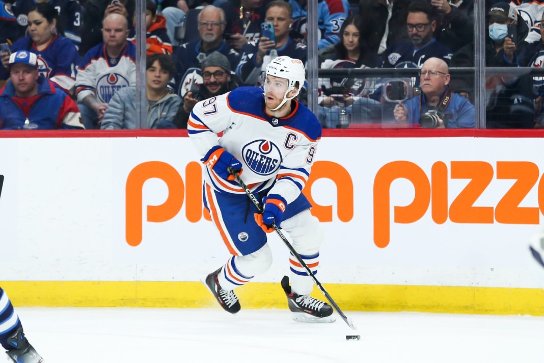 Edmonton Oilers forward Connor McDavid looks to make a pass against the Winnipeg Jets during the first period at Canada Life Centre.