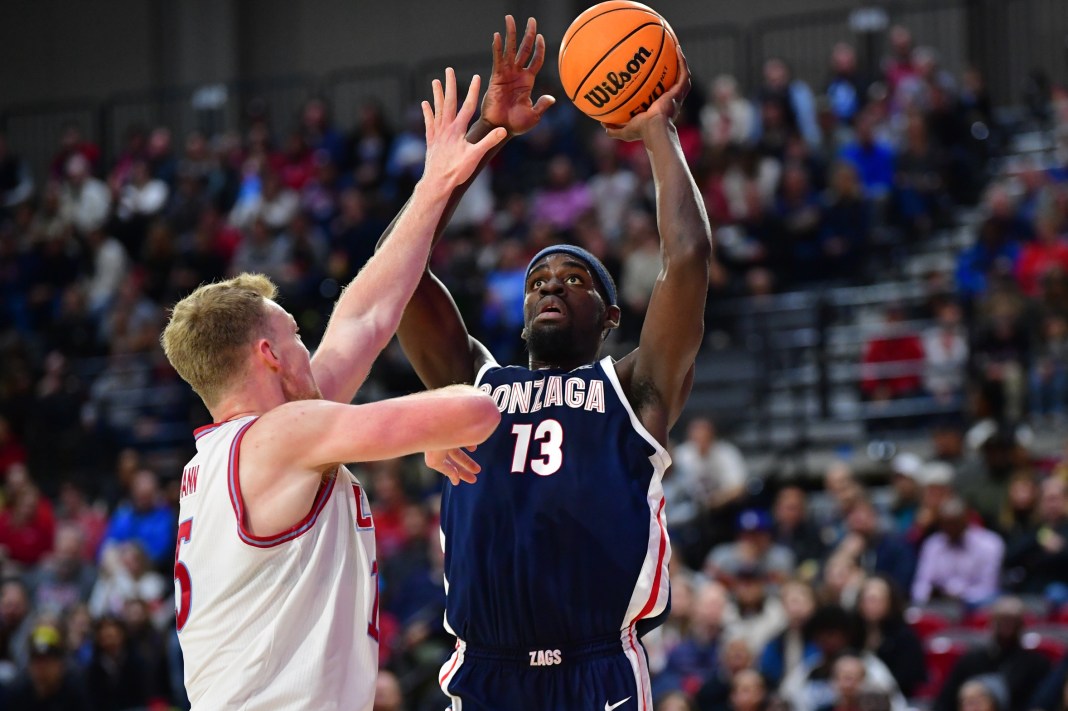 Gonzaga Bulldogs forward Graham Ike (13) shoots against Loyola Marymount Lions center Lars Thiemann (15) during the first half at Gersten Pavilion