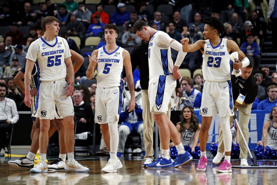 Creighton Bluejays players Baylor Scheierman, Francisco Farabello, Ryan Kalkbrenner and Trey Alexander stand on the court.