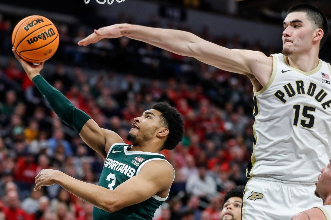 Michigan State guard Jaden Akins (3) makes a layup against Purdue center Zach Edey (15) during the second half of quarterfinal of Big Ten tournament at Target Center in Minneapolis, Minn.