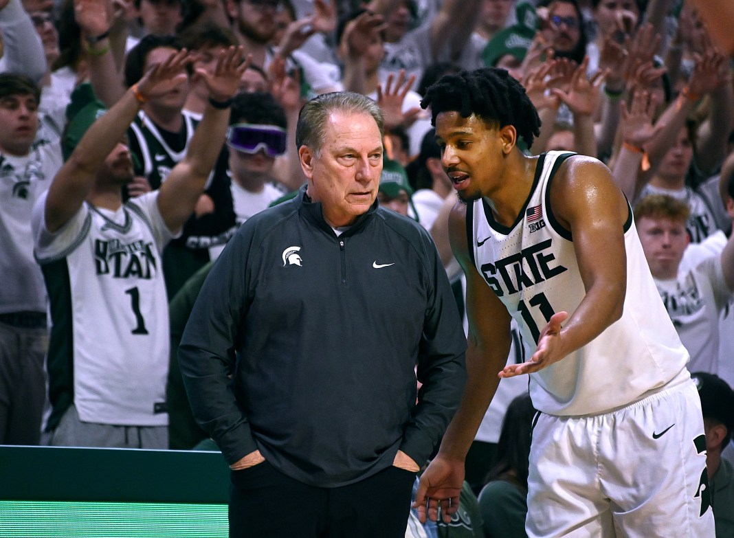 Michigan State Spartans guard A.J. Hoggard talks over a play with head coach Tom Izzo against the Northwestern Wildcats.