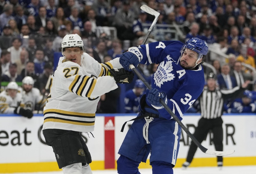 Toronto Maple Leafs forward Auston Matthews and Boston Bruins defenseman Hampus Lindholm battle during the 2024 Stanley Cup Playoffs.