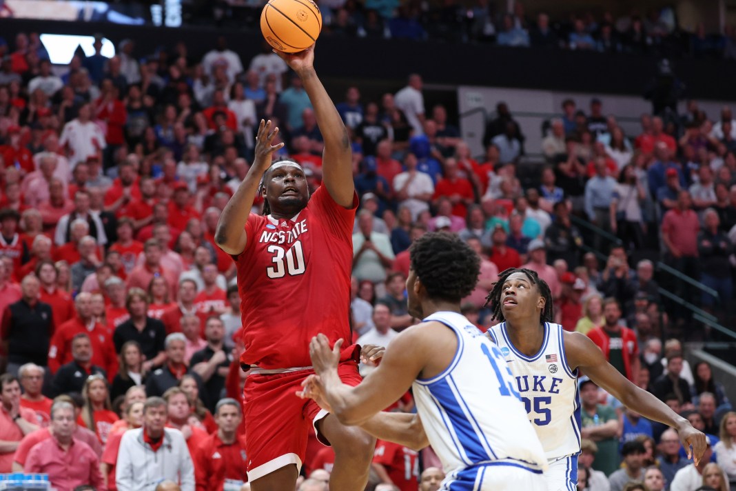 North Carolina State Wolfpack forward DJ Burns Jr. shoots against Duke Blue Devils forward Sean Stewart and forward Mark Mitchell