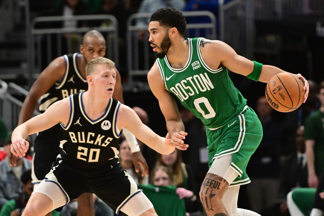 Boston Celtics forward Jayson Tatum drives past Milwaukee Bucks guard AJ Green in the second quarter at Fiserv Forum.