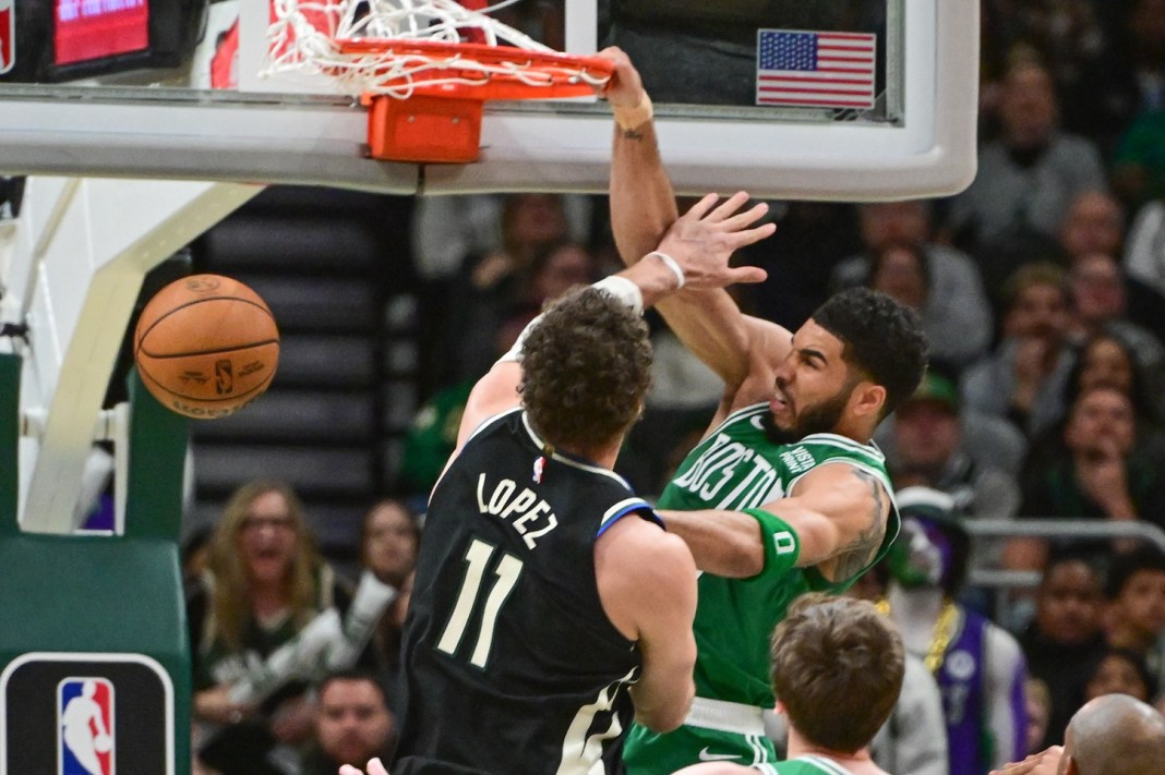 Boston Celtics forward Jayson Tatum dunks the ball against Milwaukee Bucks center Brook Lopez in the second quarter at Fiserv Forum.