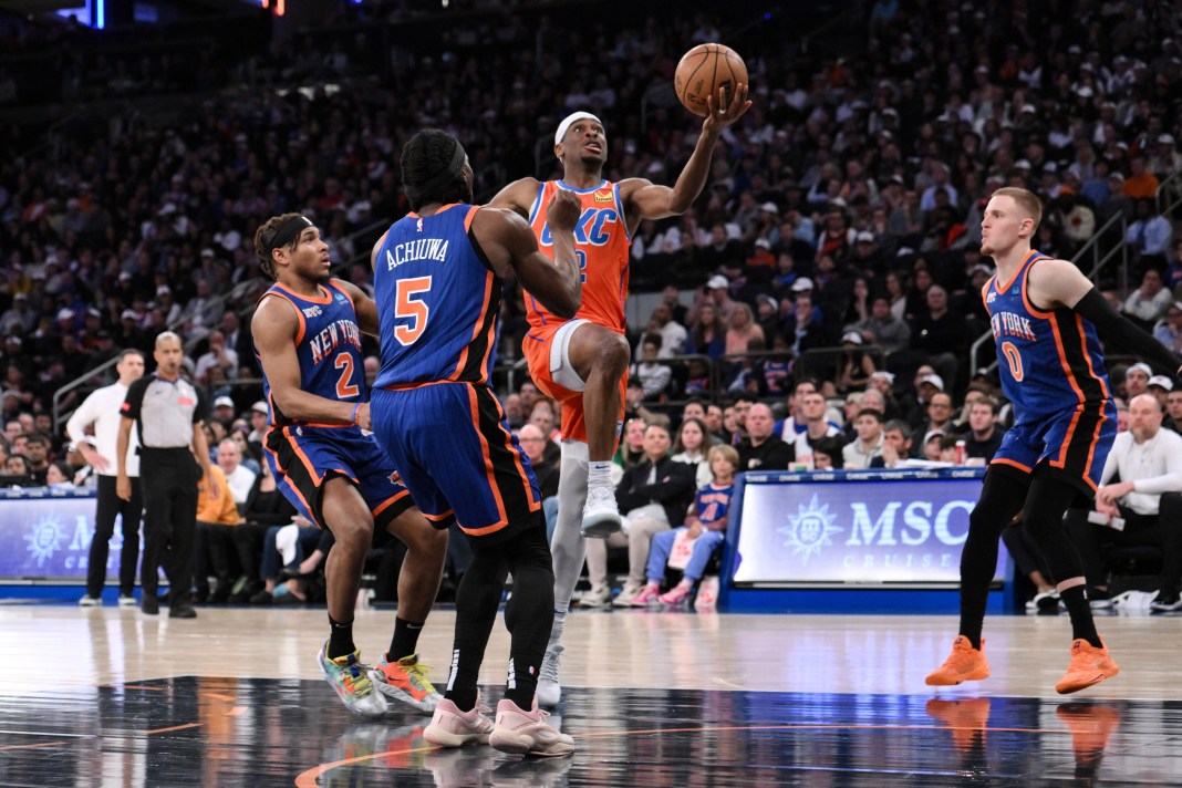 Oklahoma City Thunder guard Shai Gilgeous-Alexander (2) drives to the basket while being defended by New York Knicks guard Miles McBride (2) and New York Knicks forward Precious Achiuwa (5)