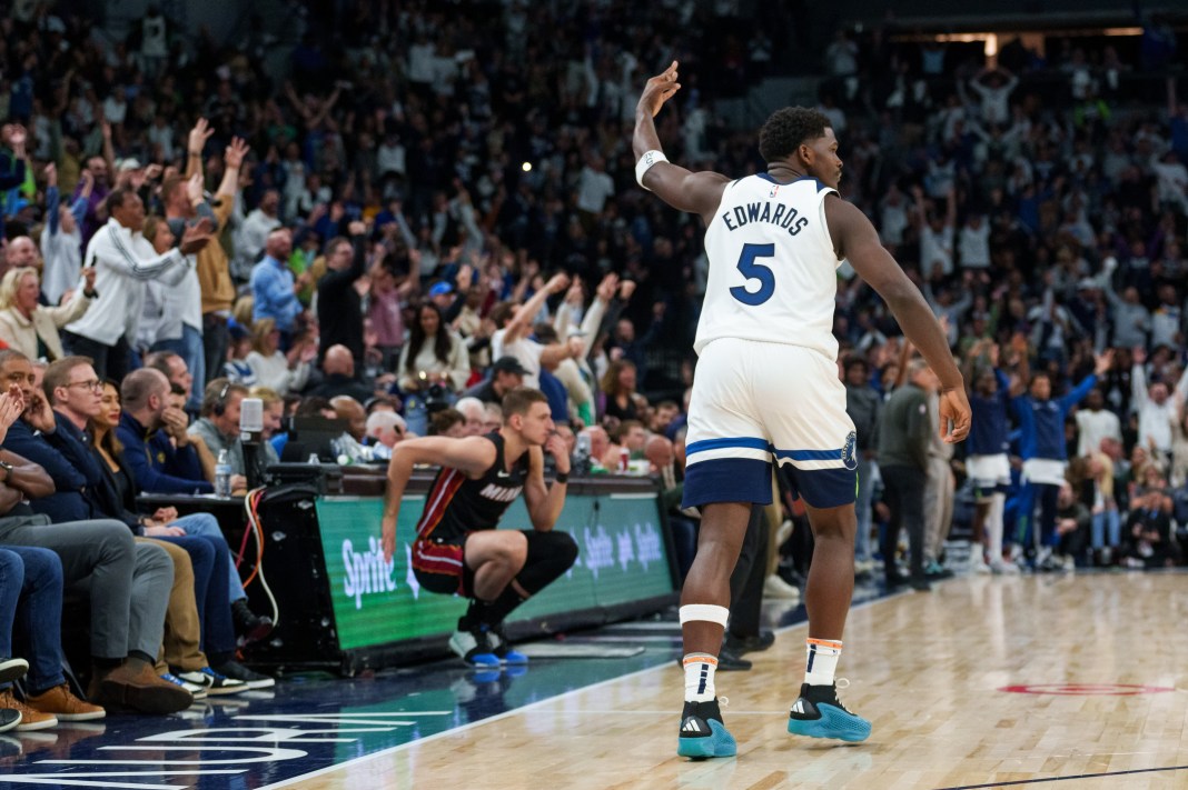 Minnesota Timberwolves guard Anthony Edwards (5) celebrates a three pointer with fans against the Miami Heat