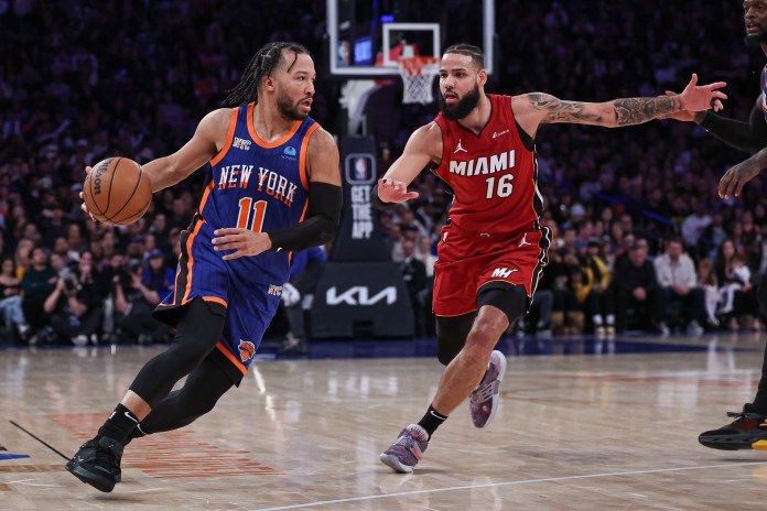 New York Knicks guard Jalen Brunson dribbles against Miami Heat forward Caleb Martin during the second half at Madison Square Garden.