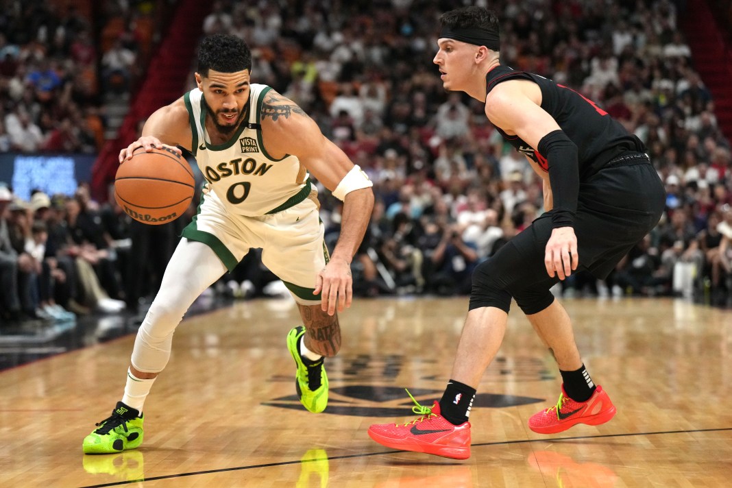 Boston Celtics forward Jayson Tatum drives to the basket as Miami Heat guard Tyler Herro defends during the first half at Kaseya Center.