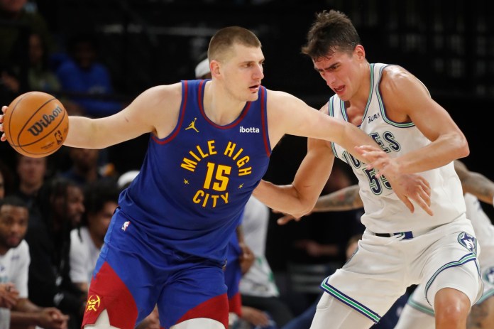 Denver Nuggets center Nikola Jokic works around Minnesota Timberwolves center Luka Garza in the fourth quarter at Target Center.