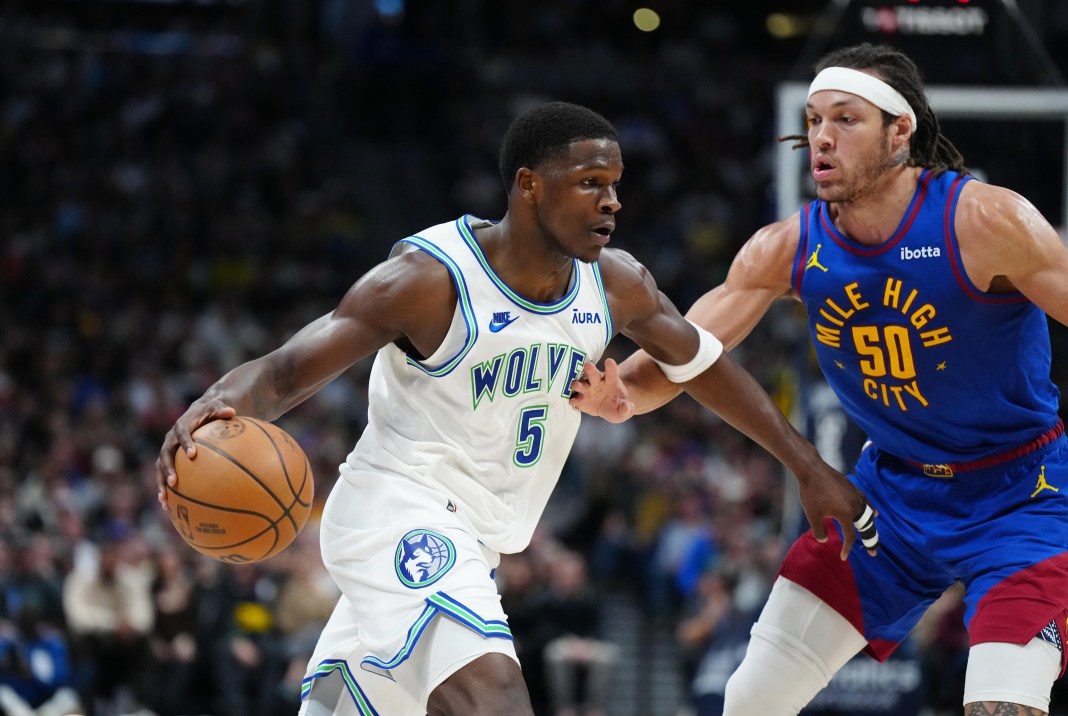 Minnesota Timberwolves guard Anthony Edwards (5) drives at Denver Nuggets forward Aaron Gordon (50)