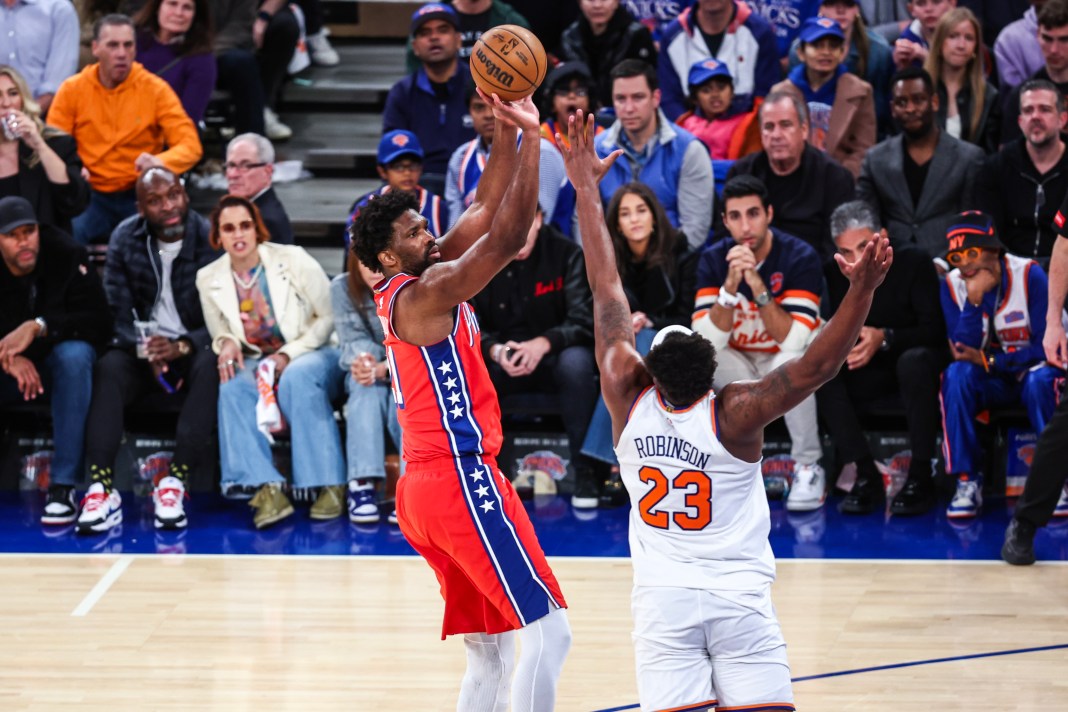 76ers center Joel Embiid shoots over Knicks center Mitchell Robinson in the 2024 NBA playoffs.