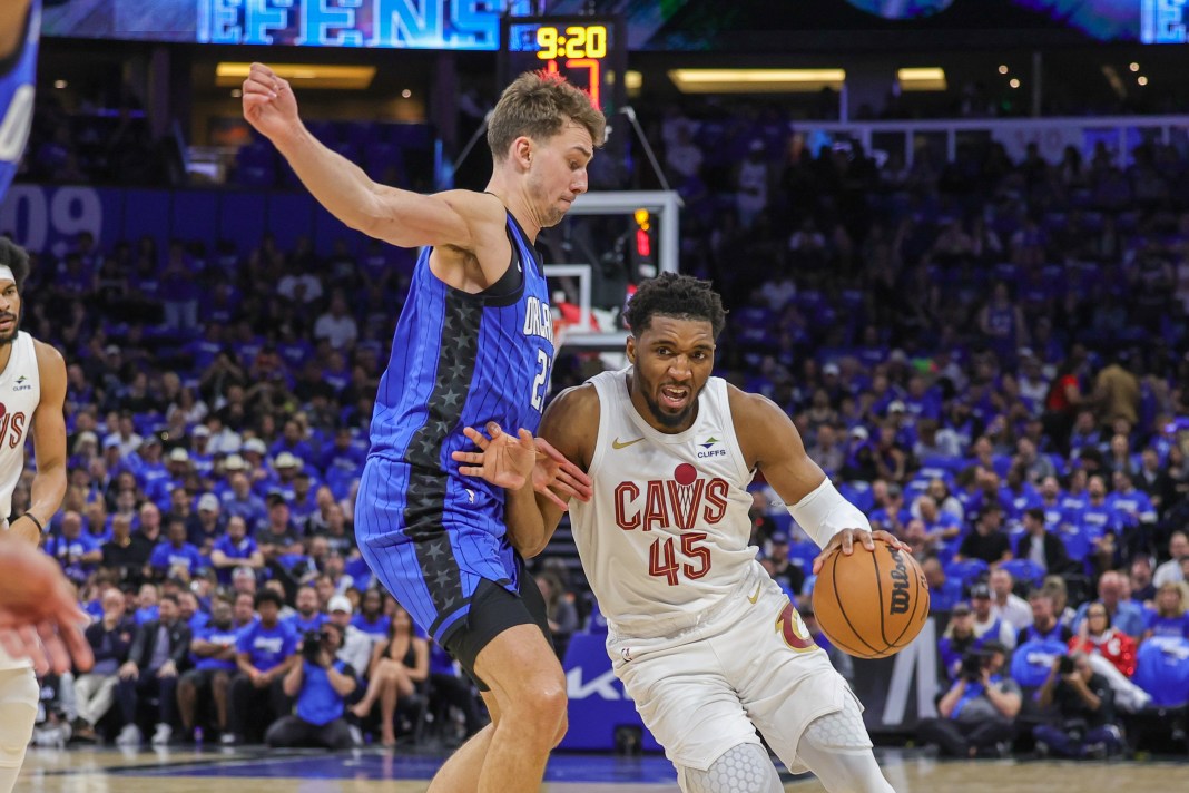 Cleveland Cavaliers guard Donovan Mitchell (45) drives around Orlando Magic forward Franz Wagner (22) during the first quarter of game three of the first round for the 2024 NBA playoffs