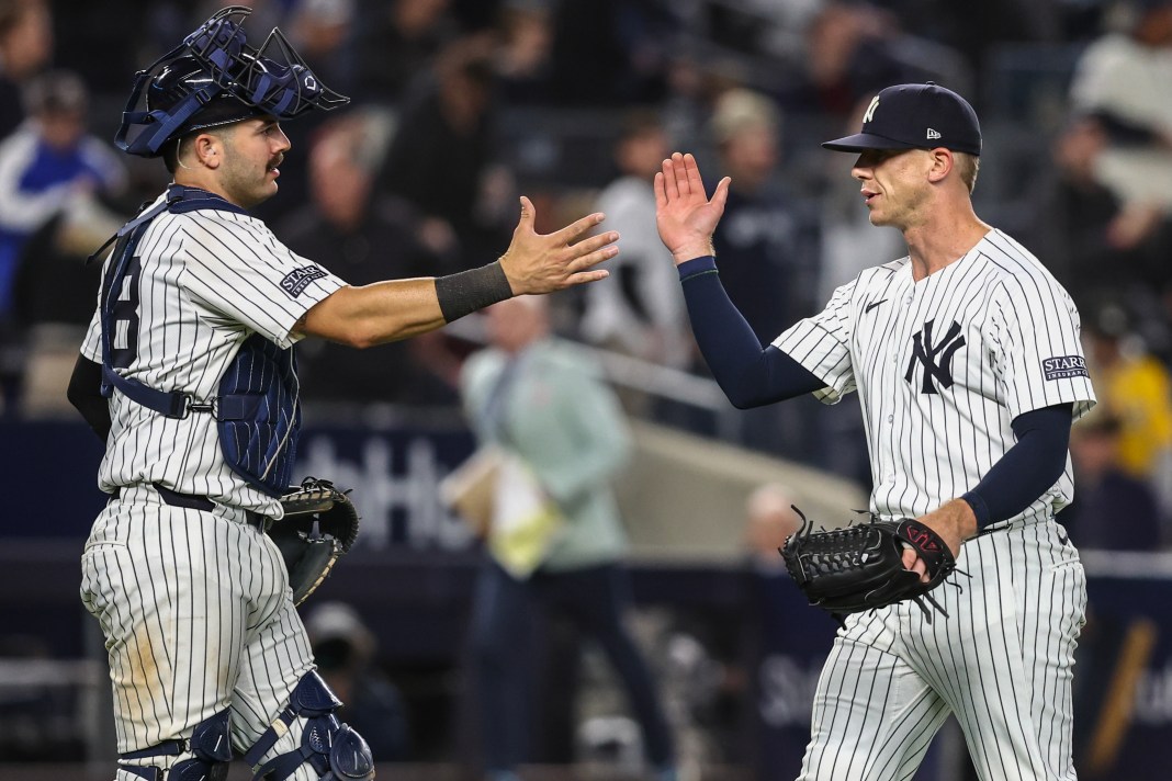 New York Yankees relief pitcher Ian Hamilton and catcher Austin Wells congratulate each other after defeating the Oakland Athletics at Yankee Stadium.