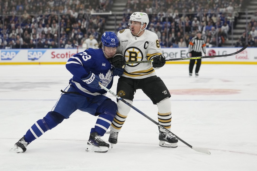 Toronto Maple Leafs forward Matthew Knies battles with Boston Bruins forward Brad Marchand in game three of the 2024 Stanley Cup Playoffs.