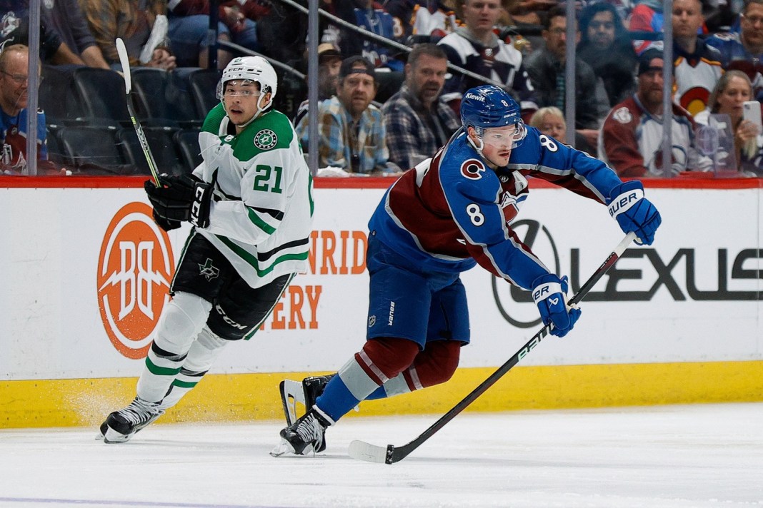 Colorado Avalanche defenseman Cale Makar passes the puck ahead of Dallas Stars left wing Jason Robertson in the 2024 Stanley Cup Playoffs.