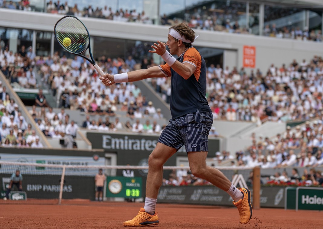 Casper Ruud returns a shot during the men's singles final against Novak Djokovic on day 15 at Stade Roland-Garros.