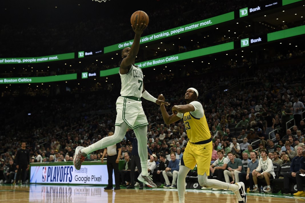 Boston Celtics guard Jaylen Brown shoots the ball against Indiana Pacers center Myles Turner in game one of the 2024 NBA playoffs.