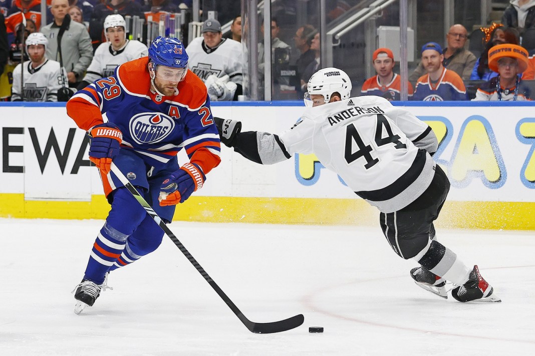 Edmonton Oilers forward Leon Draisaitl moves the puck around Los Angeles Kings defensemen Mikey Anderson in the 2024 Stanley Cup Playoffs.