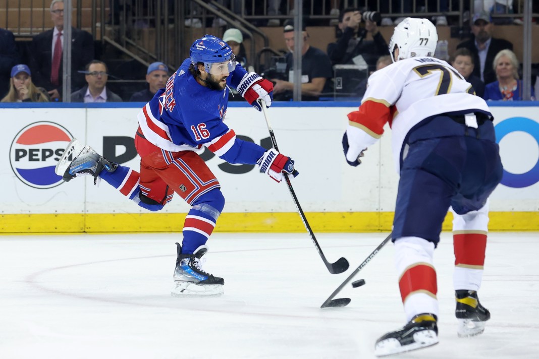 New York Rangers center Vincent Trocheck takes a shot against Florida Panthers defenseman Niko Mikkola in the 2024 Stanley Cup Playoffs.