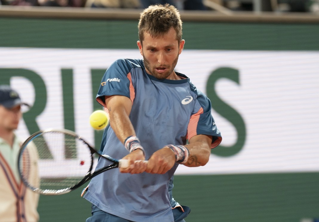 Corentin Moutet hits a backhand in his meeting with Rafael Nadal at the 2022 French Open.