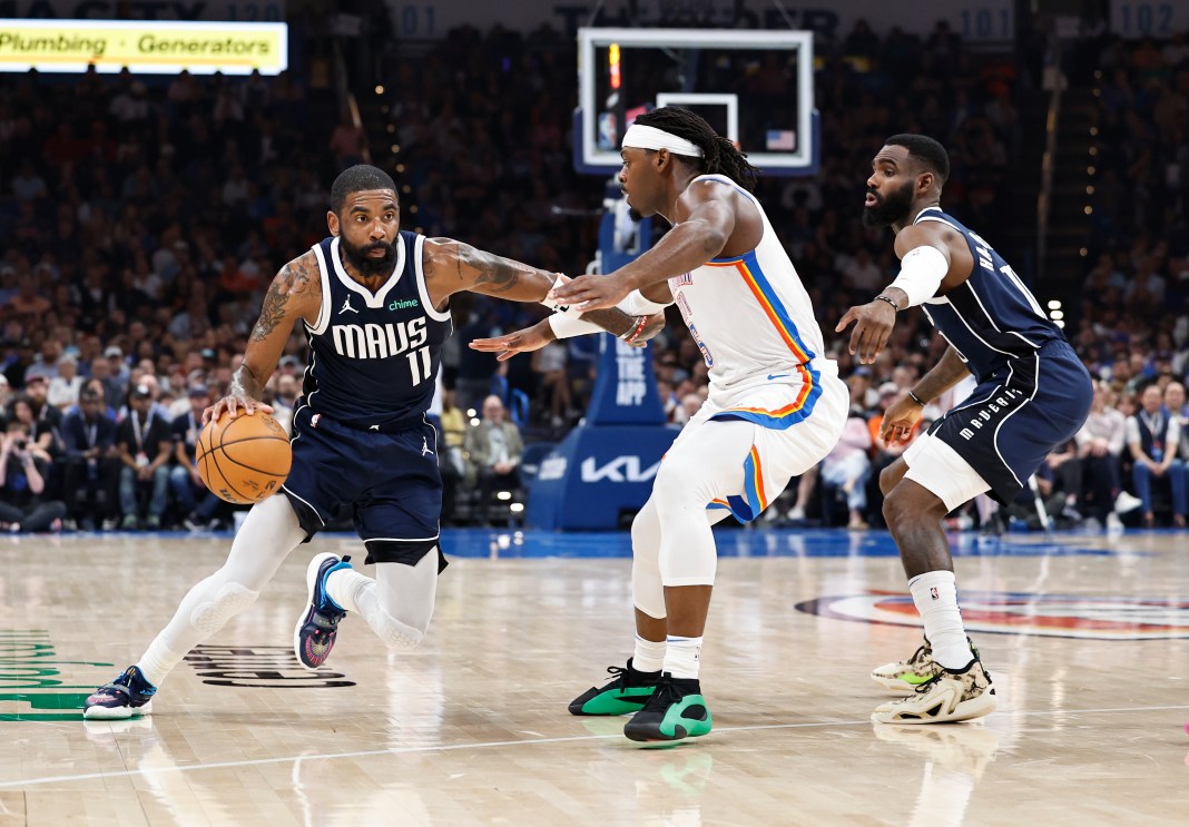 Dallas Mavericks guard Kyrie Irving (11) moves the ball around Oklahoma City Thunder guard Luguentz Dort (5) during the first half at Paycom Center