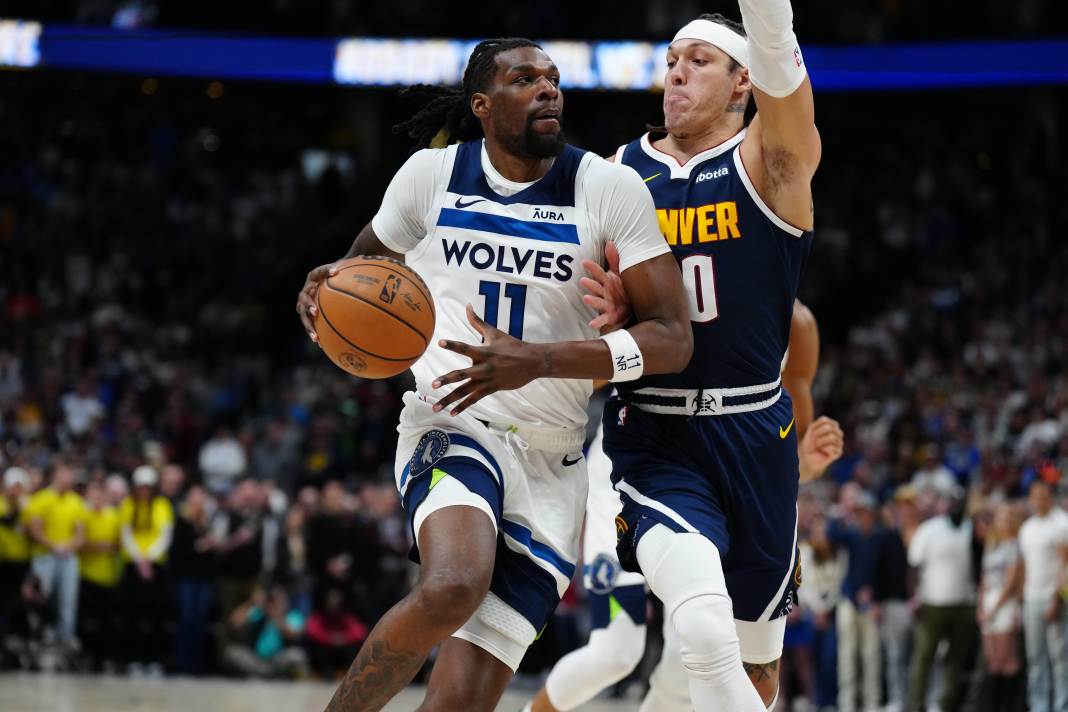 Denver Nuggets forward Aaron Gordon defends against Minnesota Timberwolves center Naz Reid in the first quarter at Ball Arena.